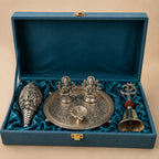 Silver Pooja Set on dark background – Thali, Sankh and Om Bell