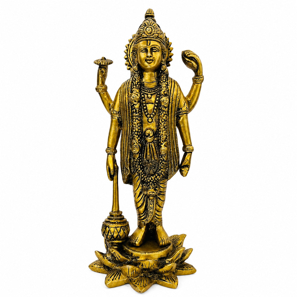 Lord Vishnu brass idol — rear view on wooden surface with diya and marigolds