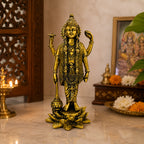 Lord Vishnu brass idol — side view on wooden surface