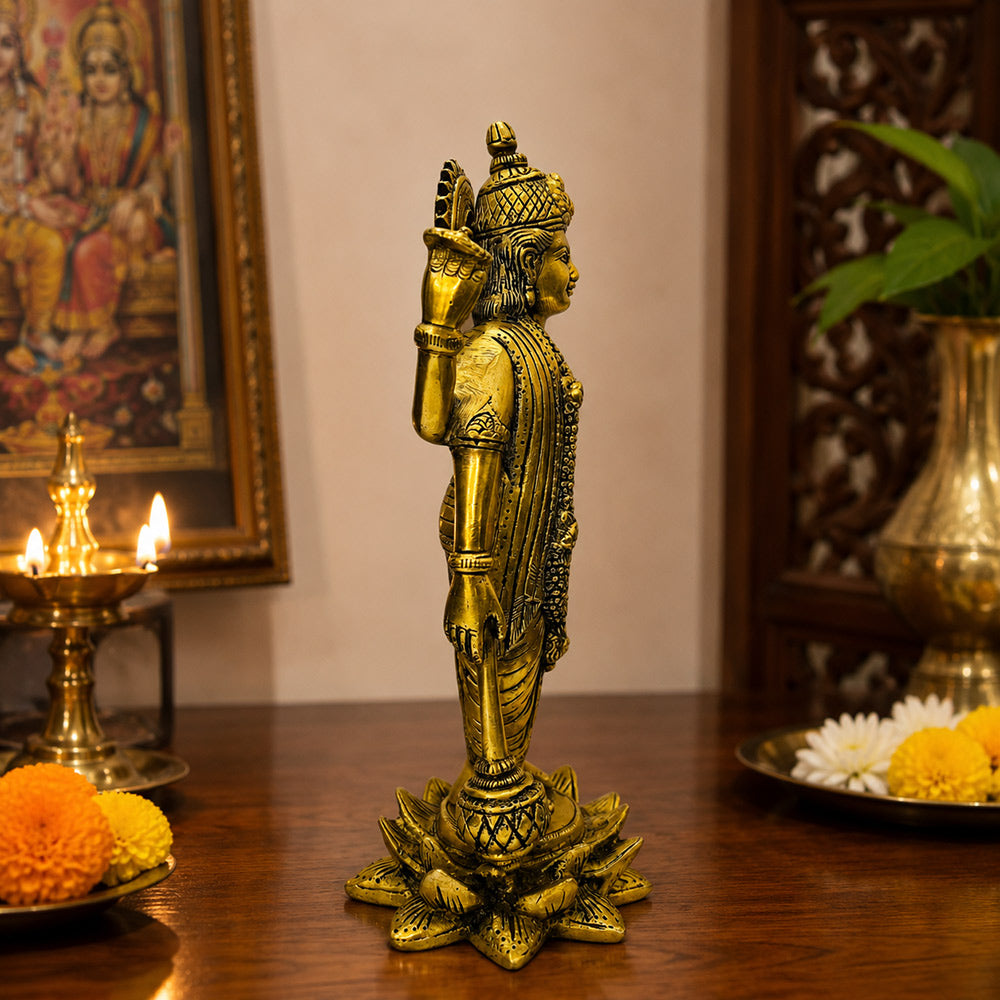 Lord Vishnu brass idol — front view on marble surface with diya