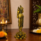 Lord Vishnu brass idol — front view on marble surface with diya